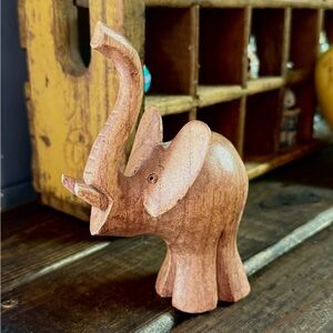 Small hand-carved wooden elephant figurine trinket.